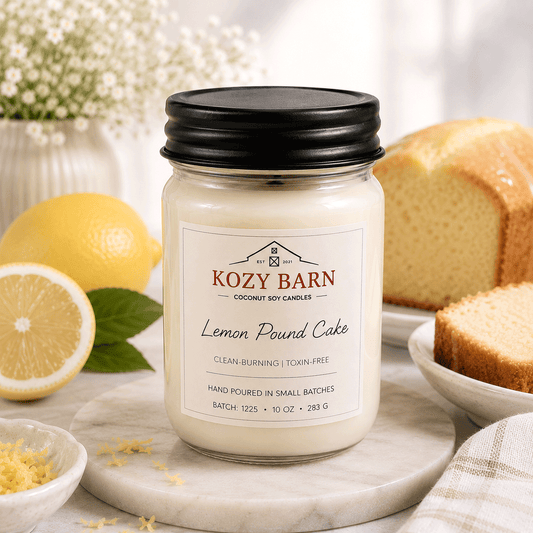 Kozy Barn candle labeled Lemon Pound Cake sitting next to freshly made lemon pound cake and sliced lemons.